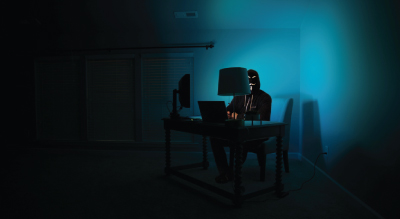 Man in dark room on computer